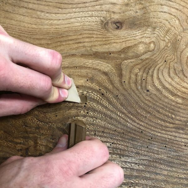 Wax fill the woodworm holes