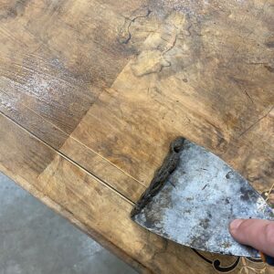 Strip the surface using a scraper 